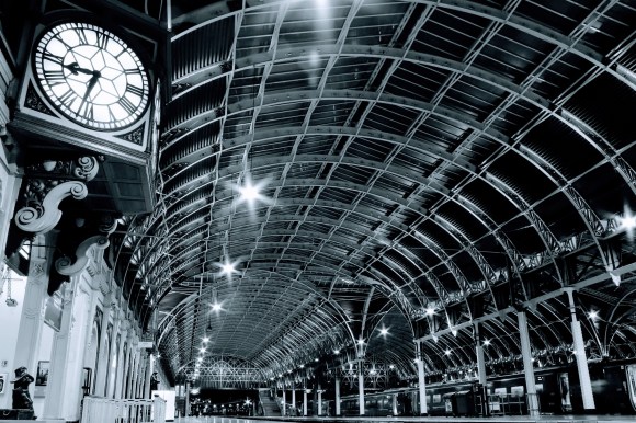 paddington sttaion at night. a view of the main GWR clock with a statue of Paddington Bear underneath