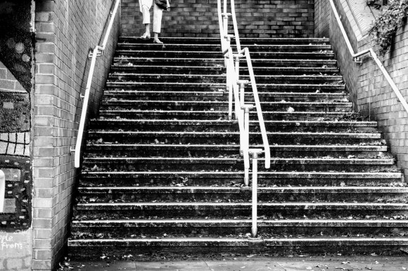 'A Step in Time' - a pedestrain walking down a flight of stairs leading to an underpass. The picture is in black and white