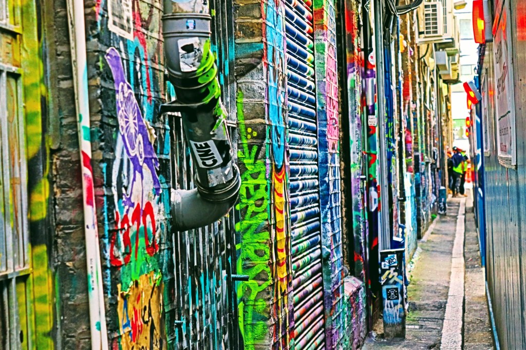 A multi-coloured graffiti alleway