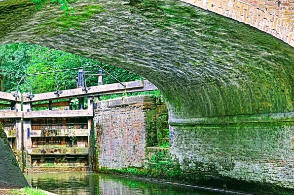 Shimmering water reflection under Cassiobury Bridge along the Grand Union Canal