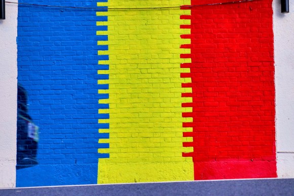 The Romanian flag colours painted on the side of a building - Blue, Yellow, Red