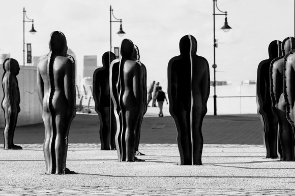 Cast iron statues caught in black and white on the banks of The Thames