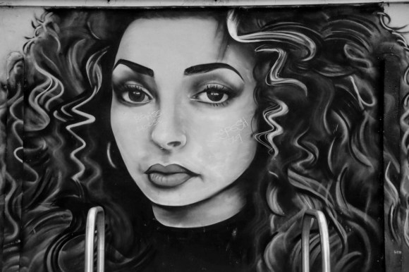 an artwork head portrait of an attractive girl with long wavy hair