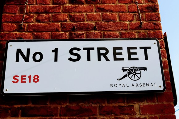 a simple street sign displaying 'No 1 Street' from SE18 in the London area of 'Royal Arsenal'