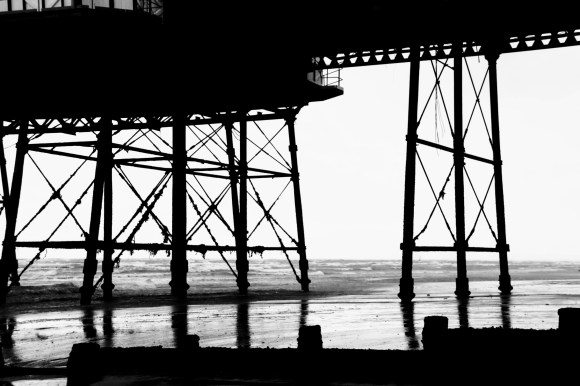 a black and white picture of eastbourne's pier supporting legs