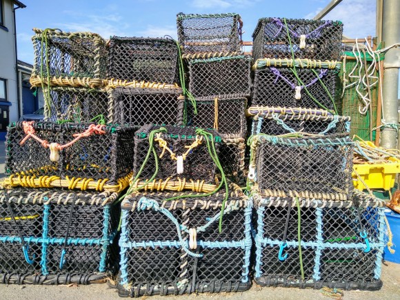a collection of lobster pots stacked on top of each other at Aberystwyth Marina
