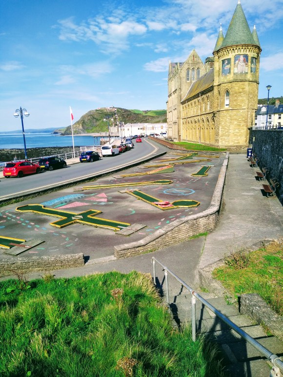 the 'old college' building on the seafront in Aberystwyth with Constitution Hill in the background