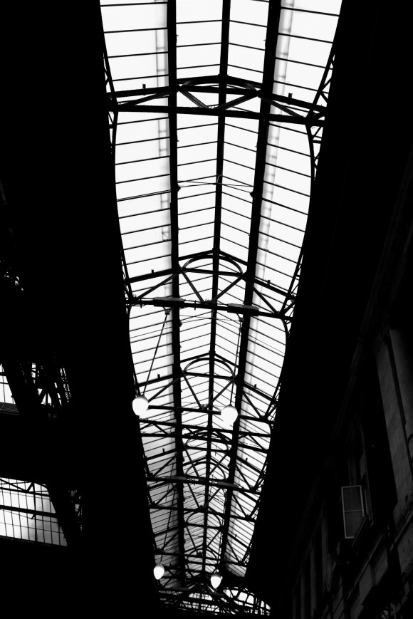 a black and white ceiling shot of the sttaion's latticed roof