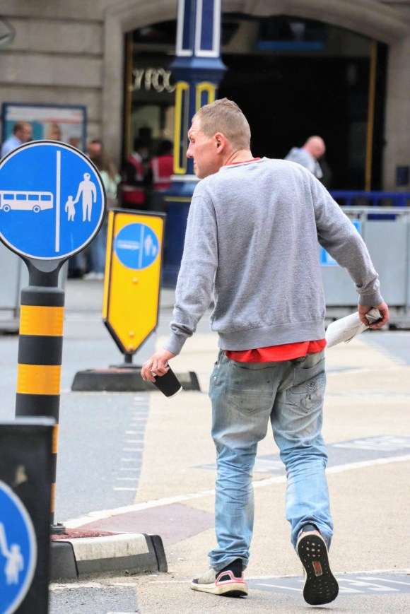 a drunkard walking in front of the station
