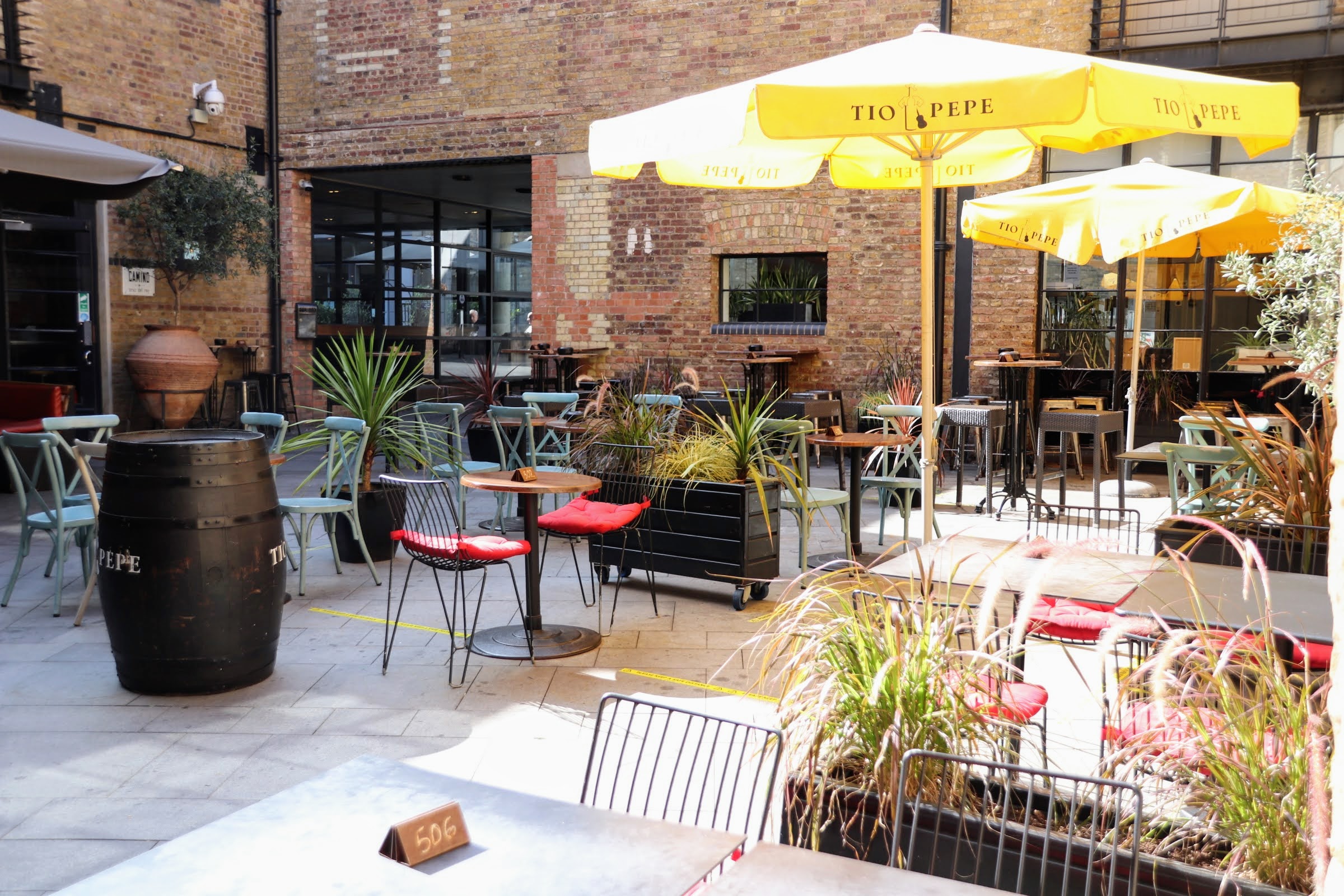 empty chairs and tables inside the open courtyard inside Regent's Quarter