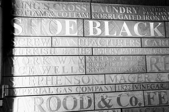 a wall plaque inside the 'Ironworks' complex promoting the complex's previous occupants e.g. laundry, shoe black, imperial gas company, screw manufacturers