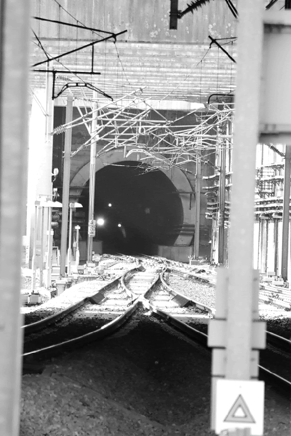 An animation of the east bound train emerging from the tunnel into the station through an array of overhead power cables