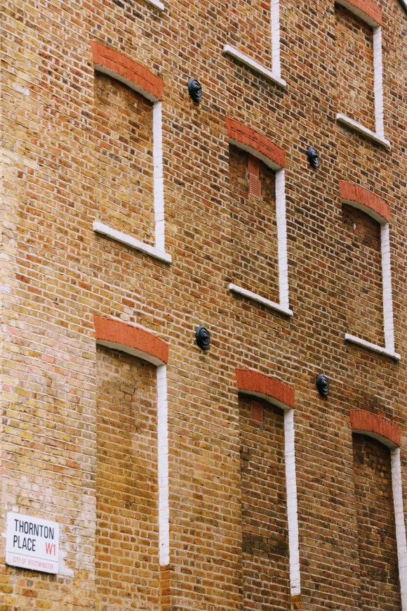 a side view of a three storey property in Thornton Place with all three windows on each floor bricked up