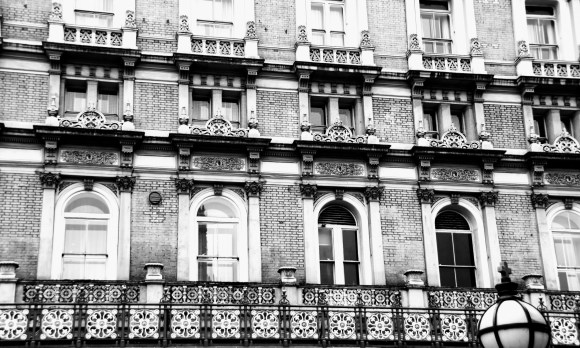 black and white image of the hotel windows above the station entrance. Decorative railings at first floor level above which are three floors of 5 windows. The winows getting smaller and less decorative the higher they are