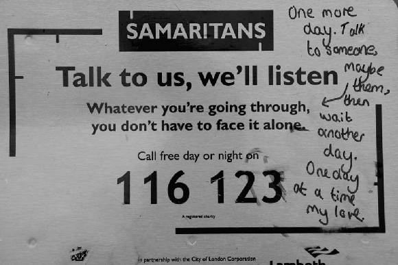 a black and white animation of two pictures flashing between the words described in the text. The main notice for the Samaritans advertising their contact number 116 123 and text 'Talk to us, we'll listen'
