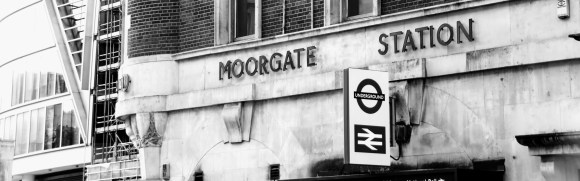 Black & White. 'Moorgate Station' sign above entrance along Moorgate with the Underground and Natiional Rail signs above the entrance